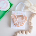 photoshoot of stock image of playdoughc/clay stamp and cutter. Eco-friendly sensory play tool perfect for creative and imaginative play. can also be used for cookies and baking. pictured is brachiosaurus