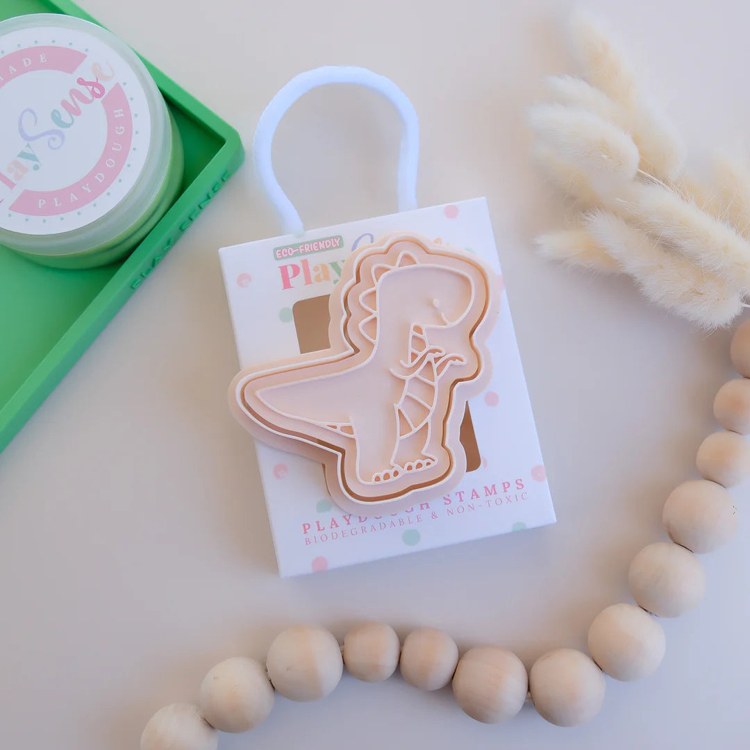 photoshoot image of playdough/clay stamp and cutter. Eco-friendly sensory play tool by brand playsense perfect for creative and imaginative play. can also be used for cookies and baking. pictured is t-rex dinosaur