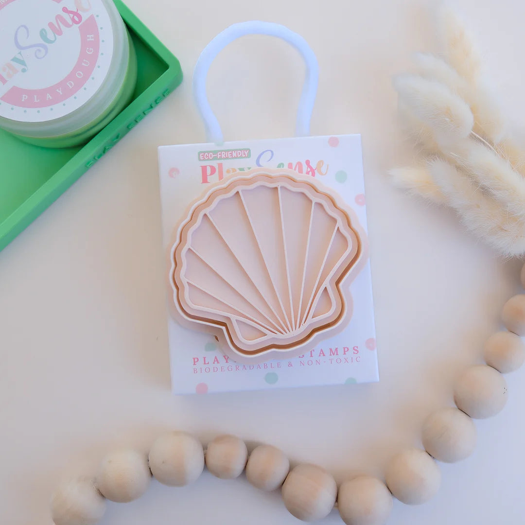 photoshoot image of playdough/clay stamp and cutter. Eco-friendly sensory play tool by brand playsense perfect for creative and imaginative play. can also be used for cookies and baking. pictured is sea shell