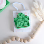 photoshoot image of playdough/clay stamp and cutter. Eco-friendly sensory play tool by brand playsense perfect for creative and imaginative play. can also be used for cookies and baking. pictured is castle