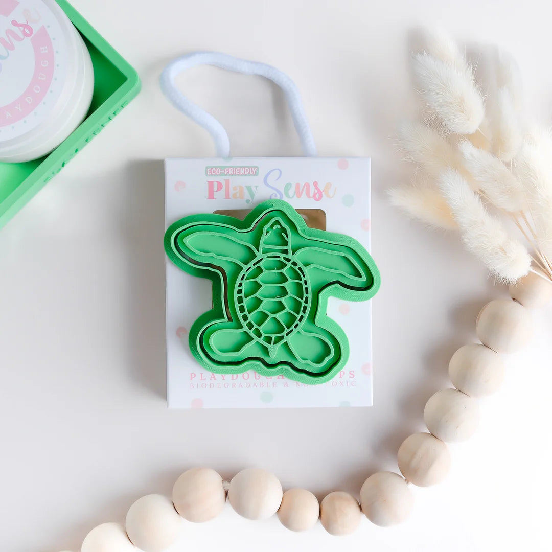 photoshoot image of playdough/clay stamp and cutter. Eco-friendly sensory play tool by brand playsense perfect for creative and imaginative play. can also be used for cookies and baking. pictured is turtle