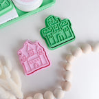 showing comparison of image of playdough/clay stamp and cutter. Eco-friendly sensory play tool by brand playsense perfect for creative and imaginative play. can also be used for cookies and baking. pictured is castle and princess castle