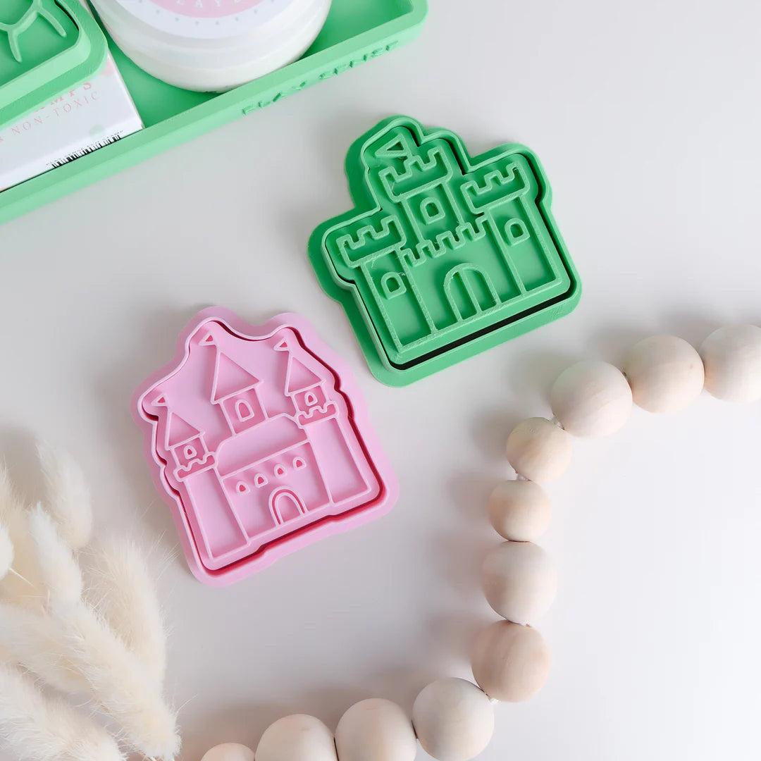 showing comparison of image of playdough/clay stamp and cutter. Eco-friendly sensory play tool by brand playsense perfect for creative and imaginative play. can also be used for cookies and baking. pictured is castle and princess castle