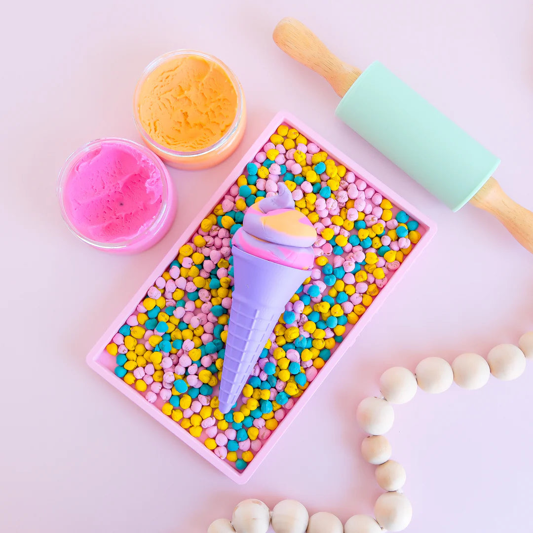photoshoot of colourful rainbow 3d printed eco ice cream cone for sensory play with clay, playdough, dough and more. brand is playsense. these are fun for kids. pictures is colours purple