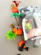 Resealable KidDough pouch with dinosaur charms, volcano accessories and textured sensory dough designed for creative pretend prehistoric play