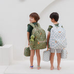 child wearing Fox & Fallow backpack for kids, perfect for school, daycare and everyday use. Spacious, practical and designed for little adventures. Personalisation of embroidery with name also available on bags in 2 placements. This print is dinos and sage check