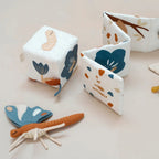 Butterfly-themed sensory activity cube made from organic cotton