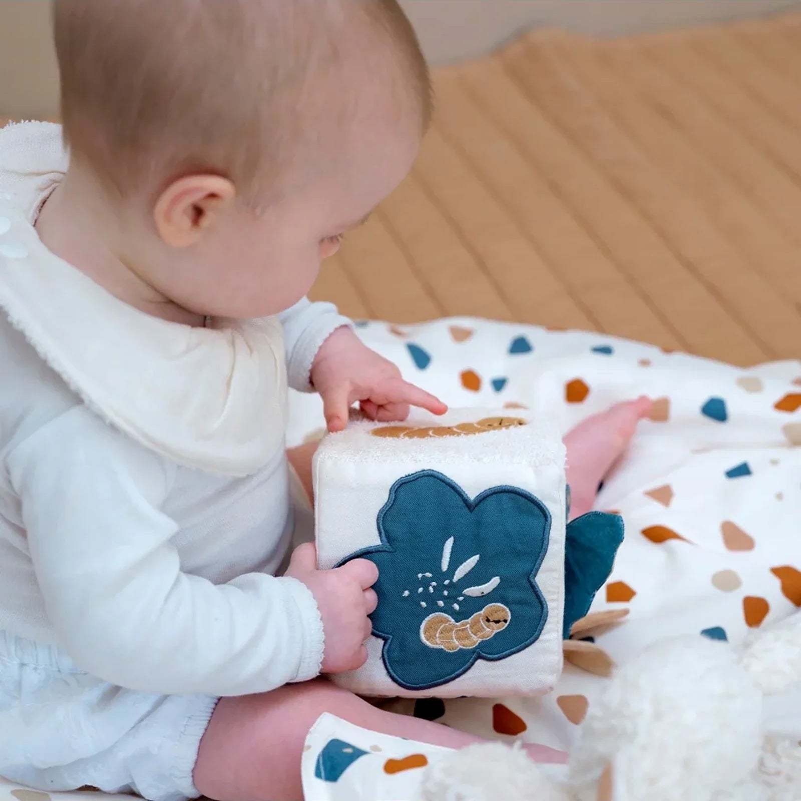 Baby activity cube with butterfly details and tactile textures