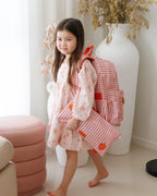 child wearing Fox & Fallow backpack for kids, perfect for school, daycare and everyday use. Spacious, practical and designed for little adventures. Personalisation of embroidery with name also available on bags in 2 placements. This print is strawberry stripe with matching pencil case