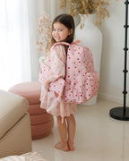 girl wearing Fox & Fallow little hearts backpack front view kids school bag with matching pencil case