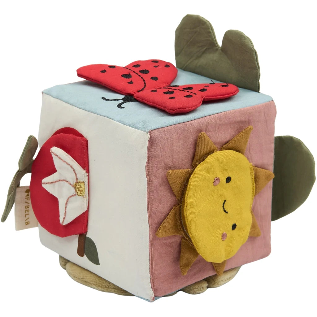 Organic cotton activity cube featuring playful garden-inspired designs