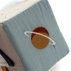 Soft educational baby toy with space-inspired fabric panels