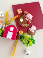Farm animal play kit with miniature barn, crops, animals and textured playdough designed for tactile sensory play and pretend farm activities