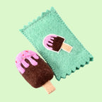 Felt ice cream popsicle toy on a green felt blanket