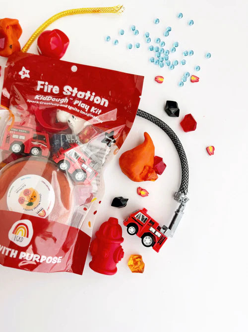 Firefighter themed sensory activity kit with playdough, fire hydrant toy, dalmatian and sensory fillers displayed beside packaging