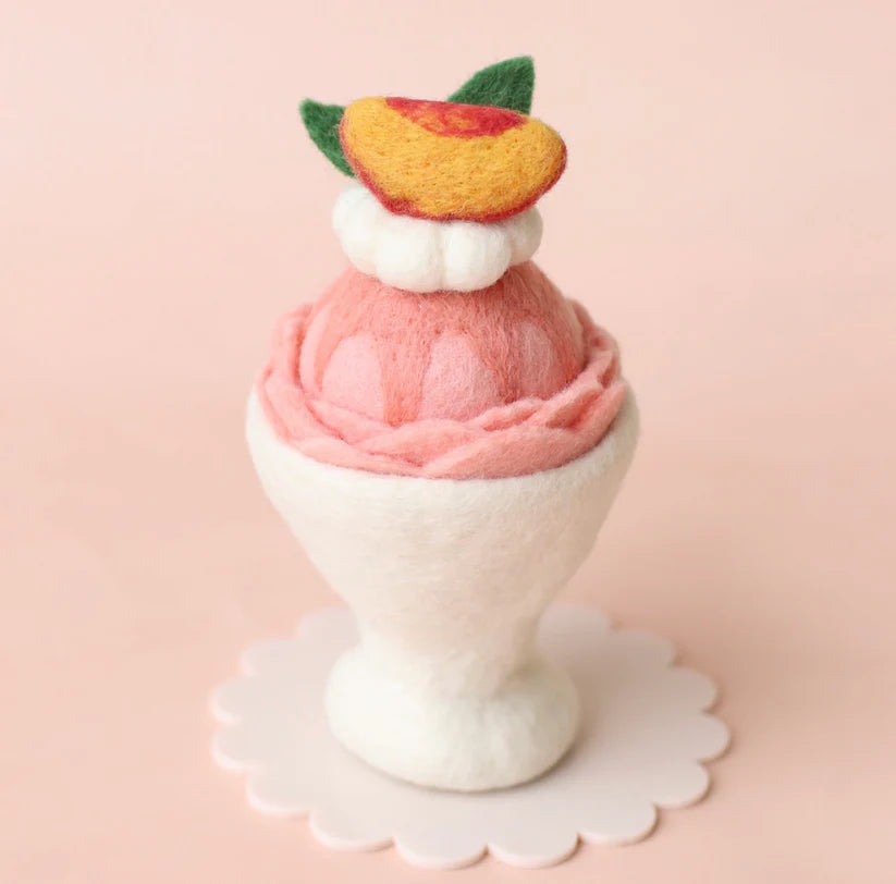Handmade peach felt ice cream sundae with whipped cream and fruit topping for imaginative play kitchens