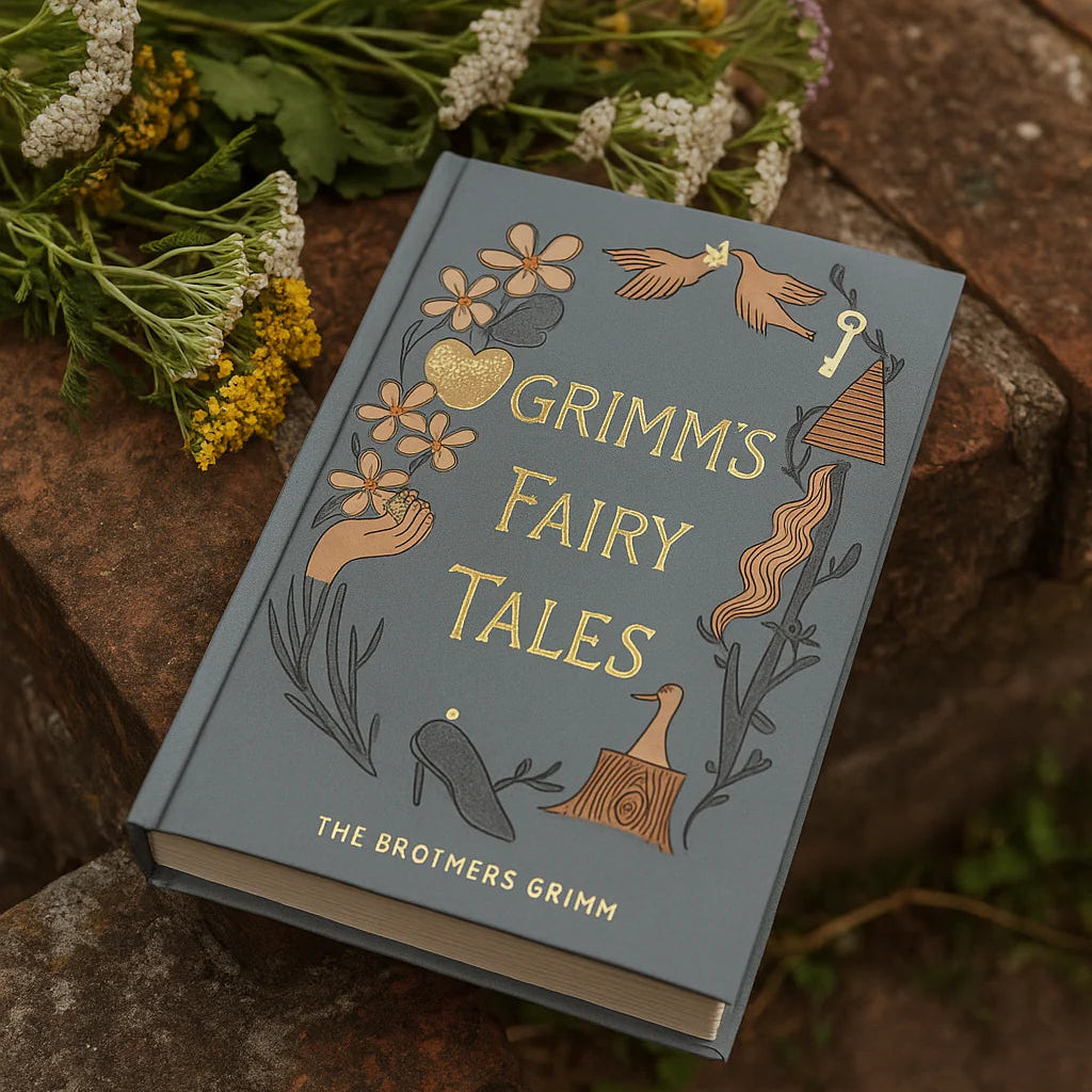 photoshoot of Grimm’s Fairy Tales collector’s edition hardback book with illustrated cover and gold foil lettering featuring classic fairytale stories