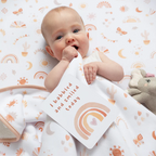 baby in a photoshoot with milestone cards by lively living to track babies age and milestones. great for photos and theme is bohemian bliss. card pictured reads i babbled and smiled today. 