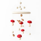Woodland felt baby mobile with handmade red mushroom and acorn decorations by Ganapati