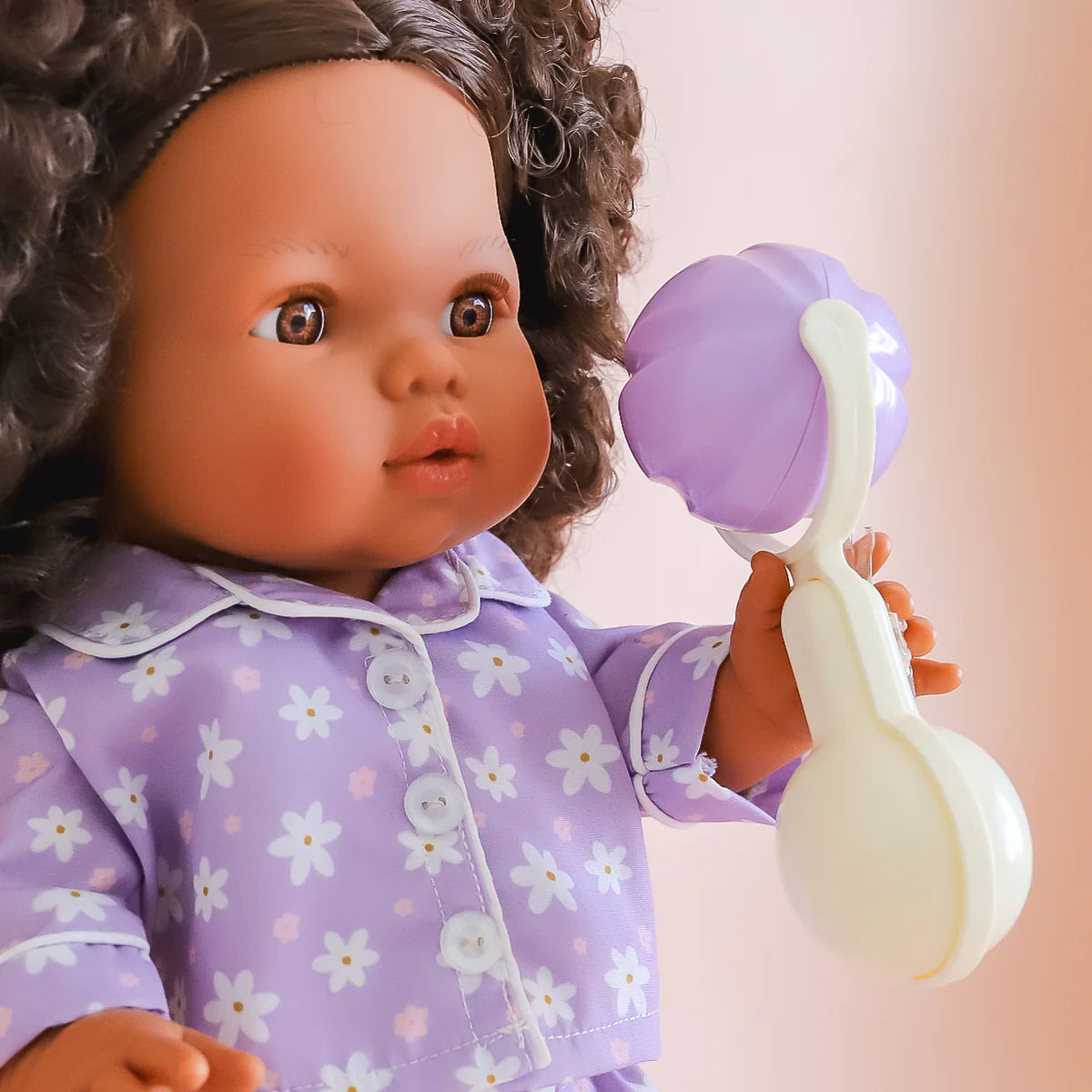 detailed picture of the tiny tummies sleepytime pack gift set out of packaging, includes lilac daisy printed pyjamas for your doll, doll slippers, magic milk and play rattle for your doll and pretend play. brand is tiny harlow