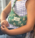 child wearing crossbody kids bag by picnic folk in green cheetah
