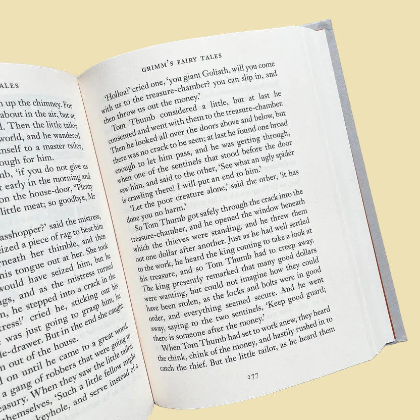 inside of Grimm’s Fairy Tales collector’s edition hardback book with illustrated cover and gold foil lettering featuring classic fairytale stories
