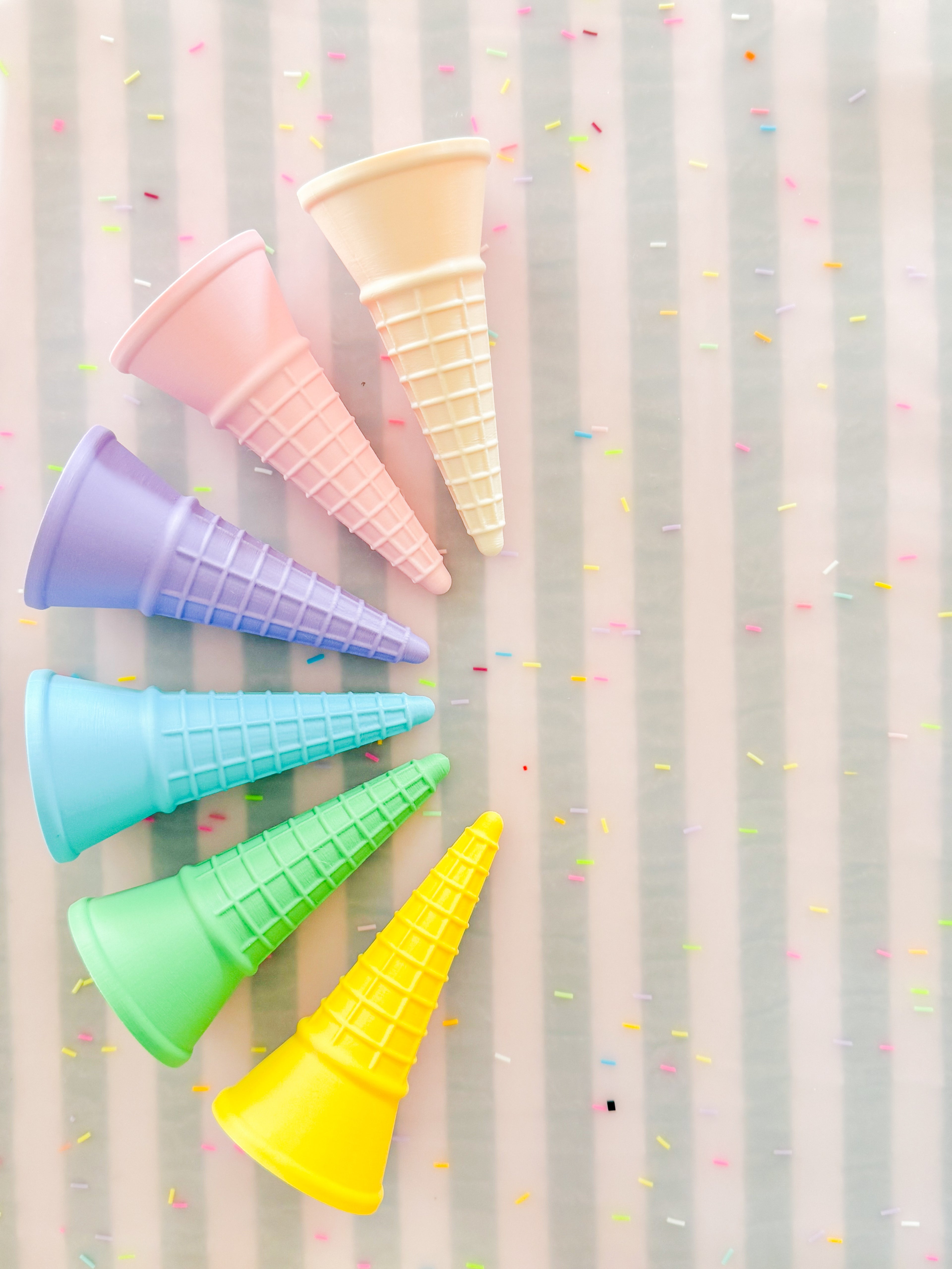 showing off colourful rainbow 3d printed eco ice cream cone for sensory play with clay, playdough, dough and more. brand is playsense. these are fun for kids. pictures is colours pink, beige, green, blue, purple and yellow
