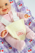 close up of cherry gingham  Dolls Car Seat Capsule by tiny harlow with a doll inside