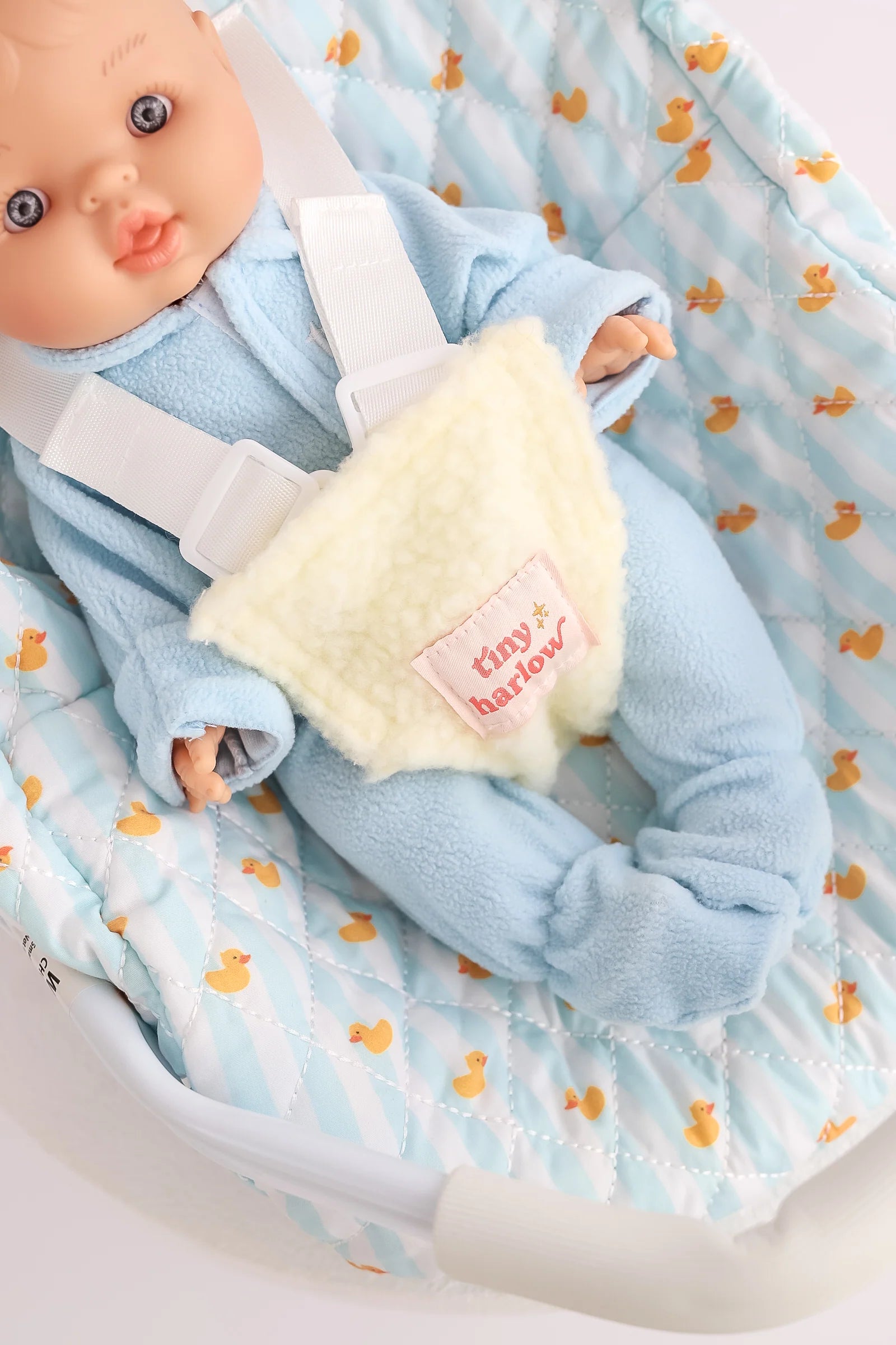 another close up of blue ducky Dolls Car Seat Capsule by tiny harlow with a little boy doll inside