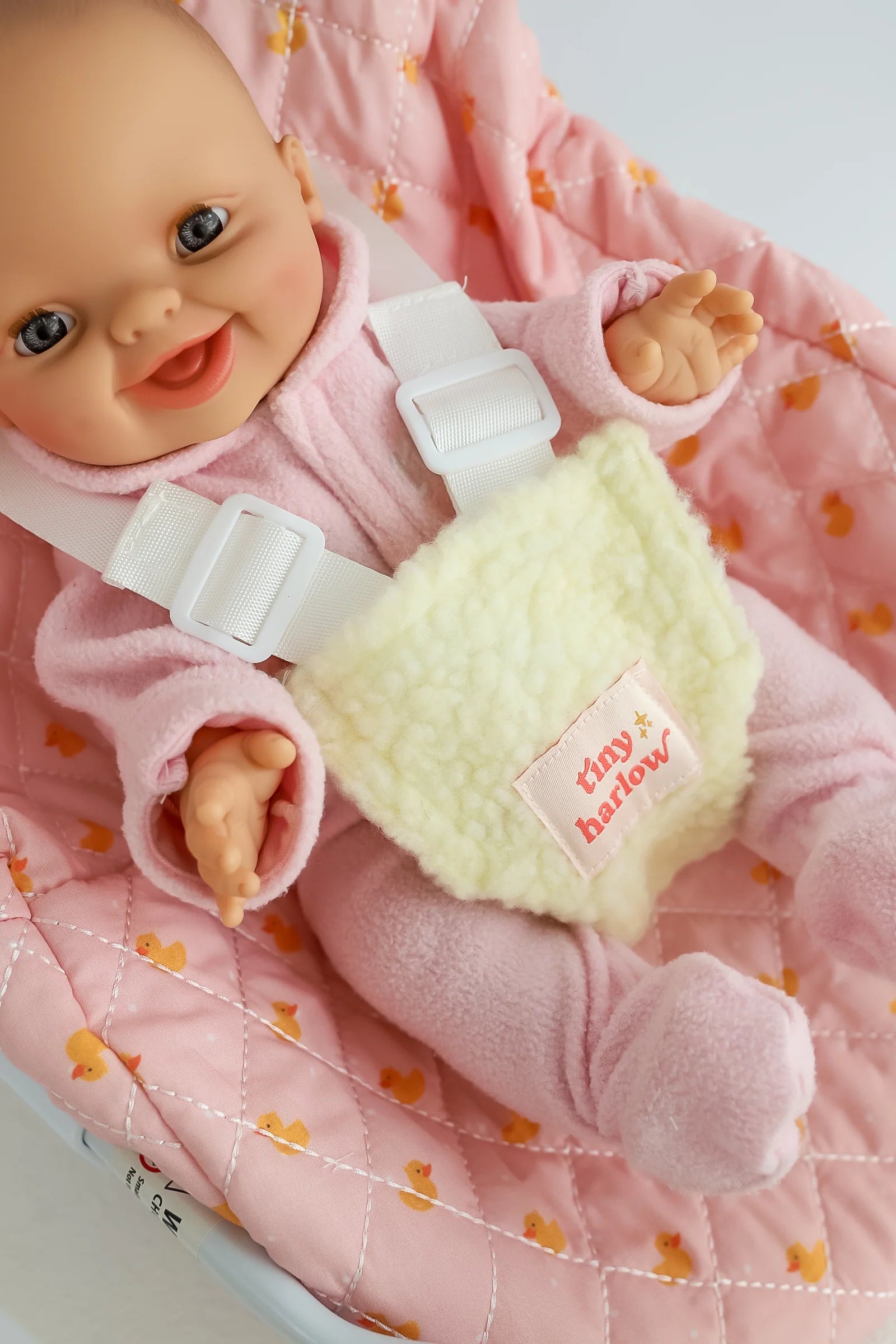 close up of pink ducky Dolls Car Seat Capsule by tiny harlow with a doll inside