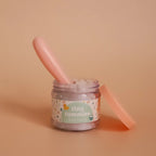 a closer look at just the tiny tummies jar of baby cereal with it's magic spoon. brand is tiny harlow 