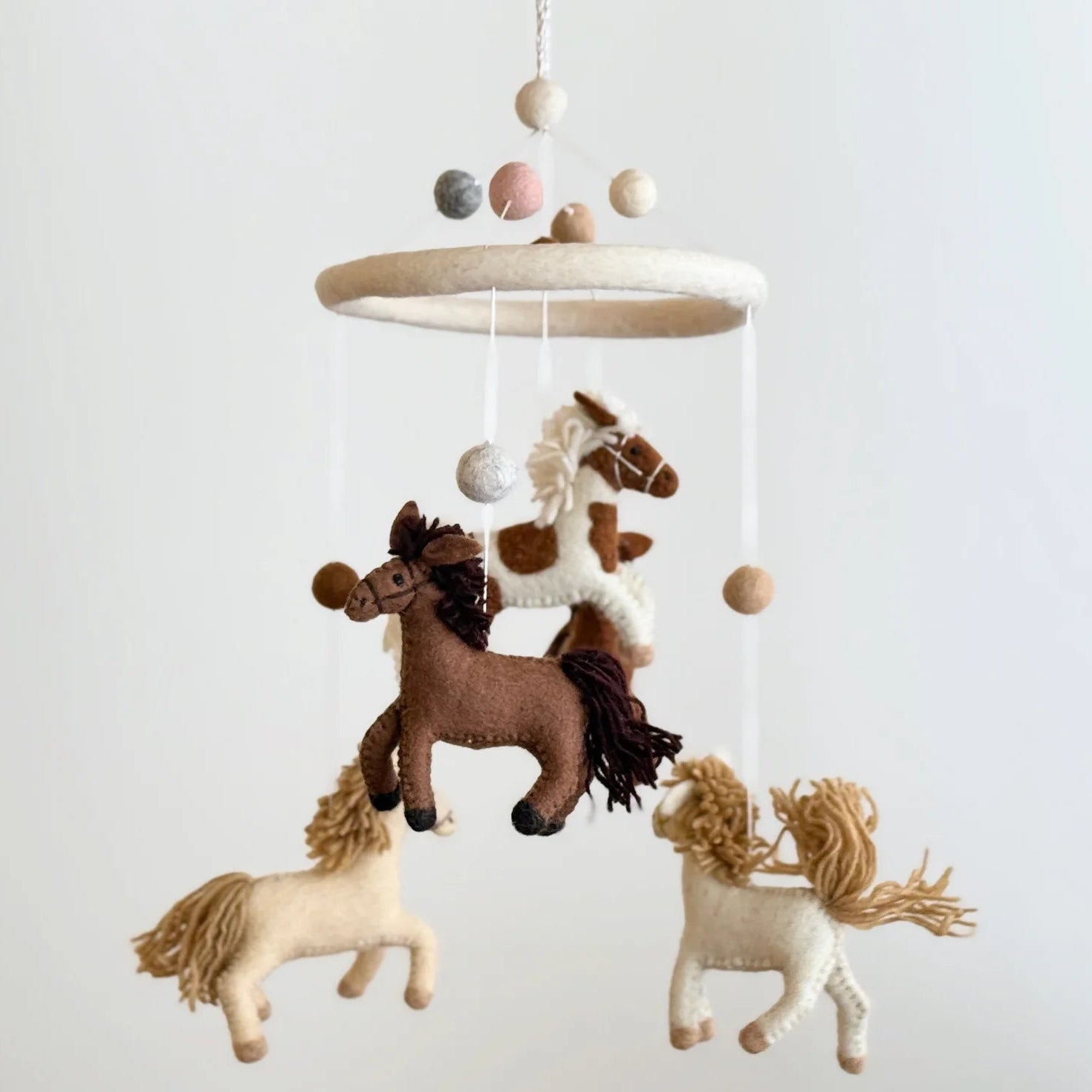 Horse Felt Baby Mobile by Ganapati with handmade wool felt horses hanging from wooden frame