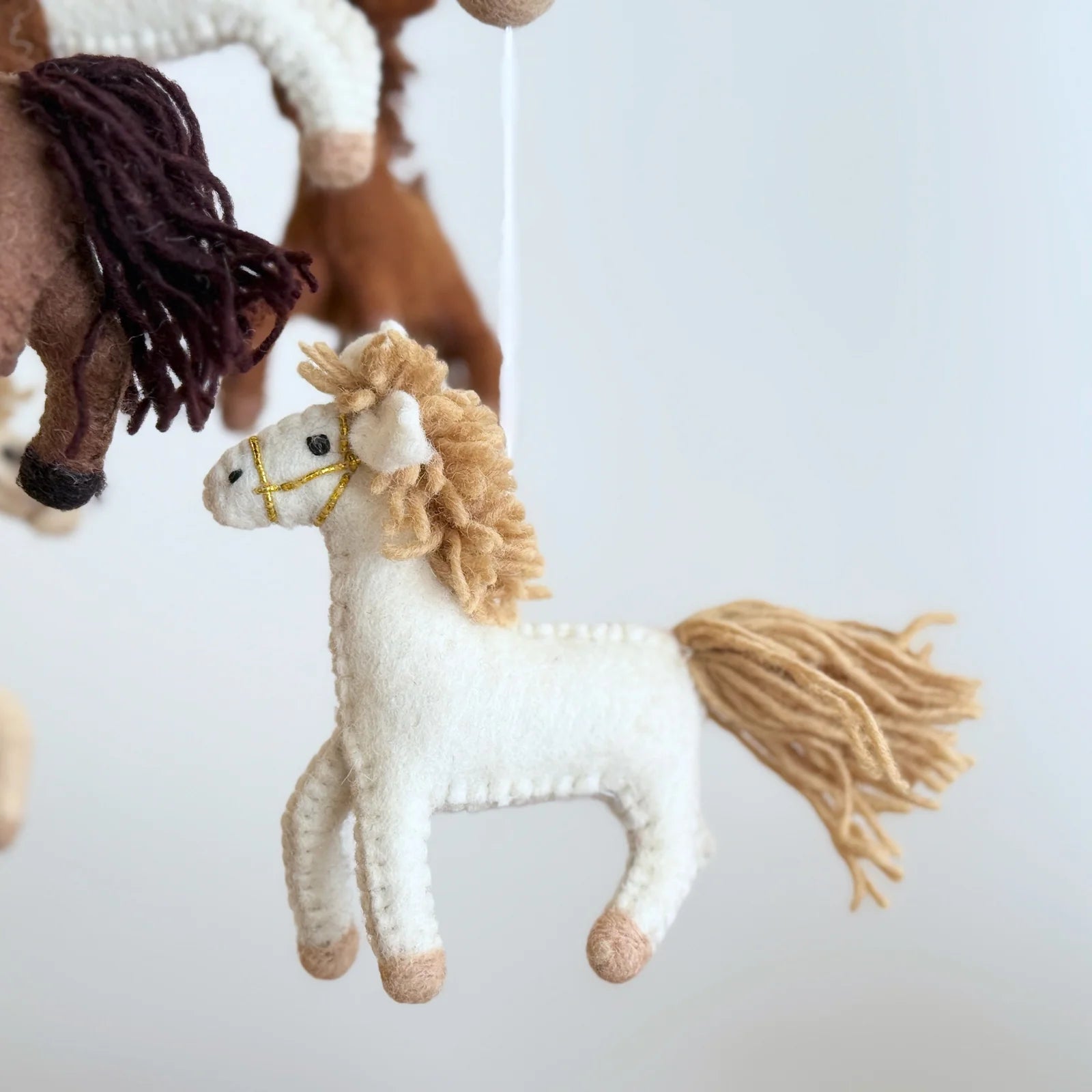 Ganapati Horse Felt Baby Mobile featuring handcrafted wool felt horses in neutral tones