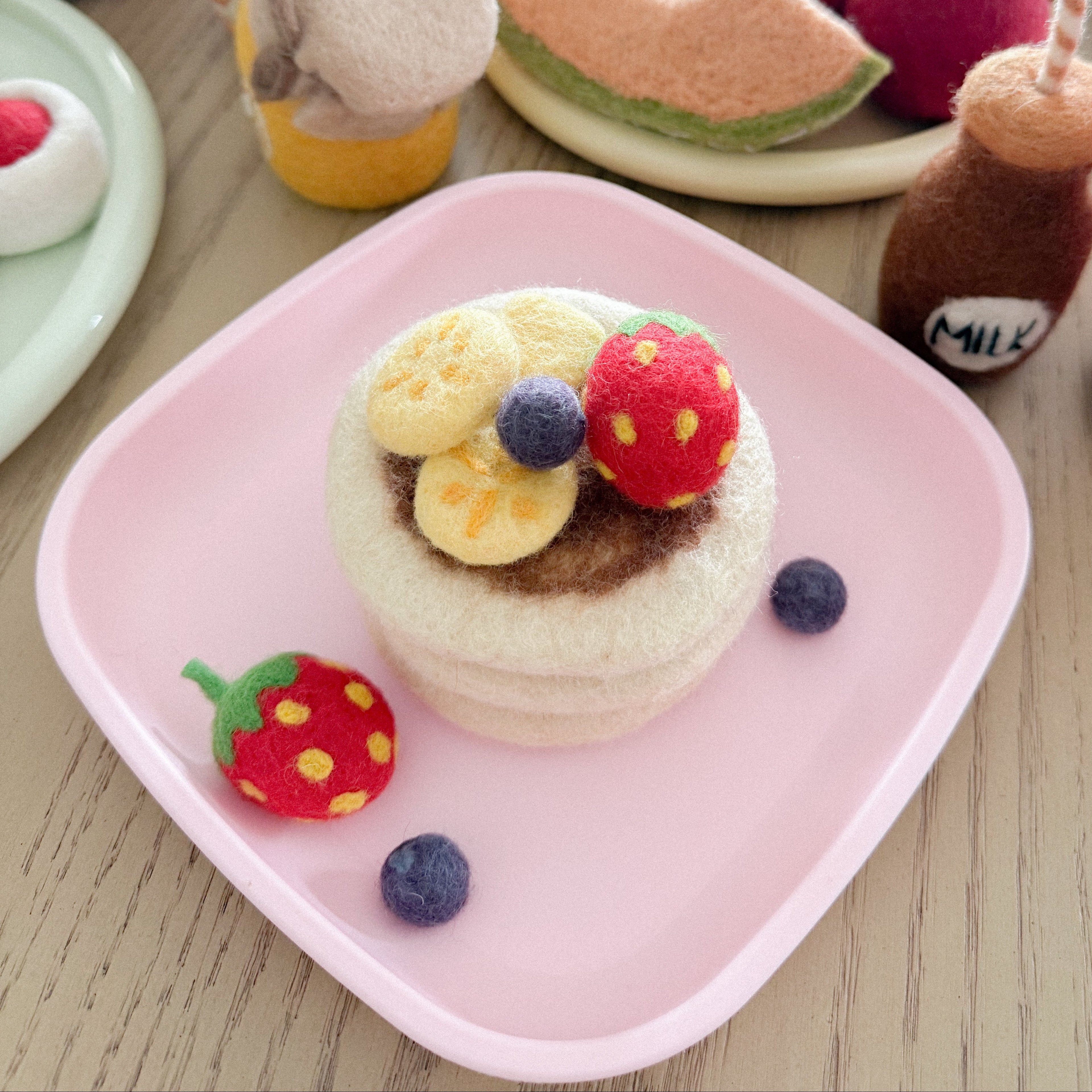 set up with a lot of other felt food felt pancake stack toy set handmade wool pretend play food with berries and banana Tara Treasures