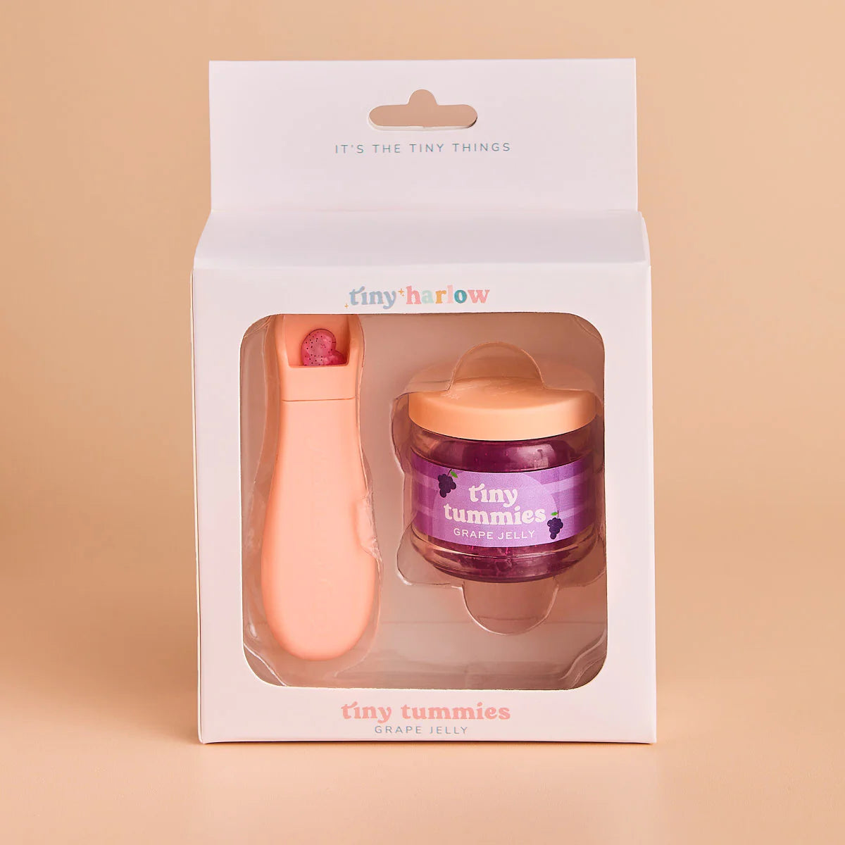 packaging of jar of tiny tummies pretend baby dolls food which is magic and disappearing, perfect gifting brand is tiny harlow and flavour is grape jelly