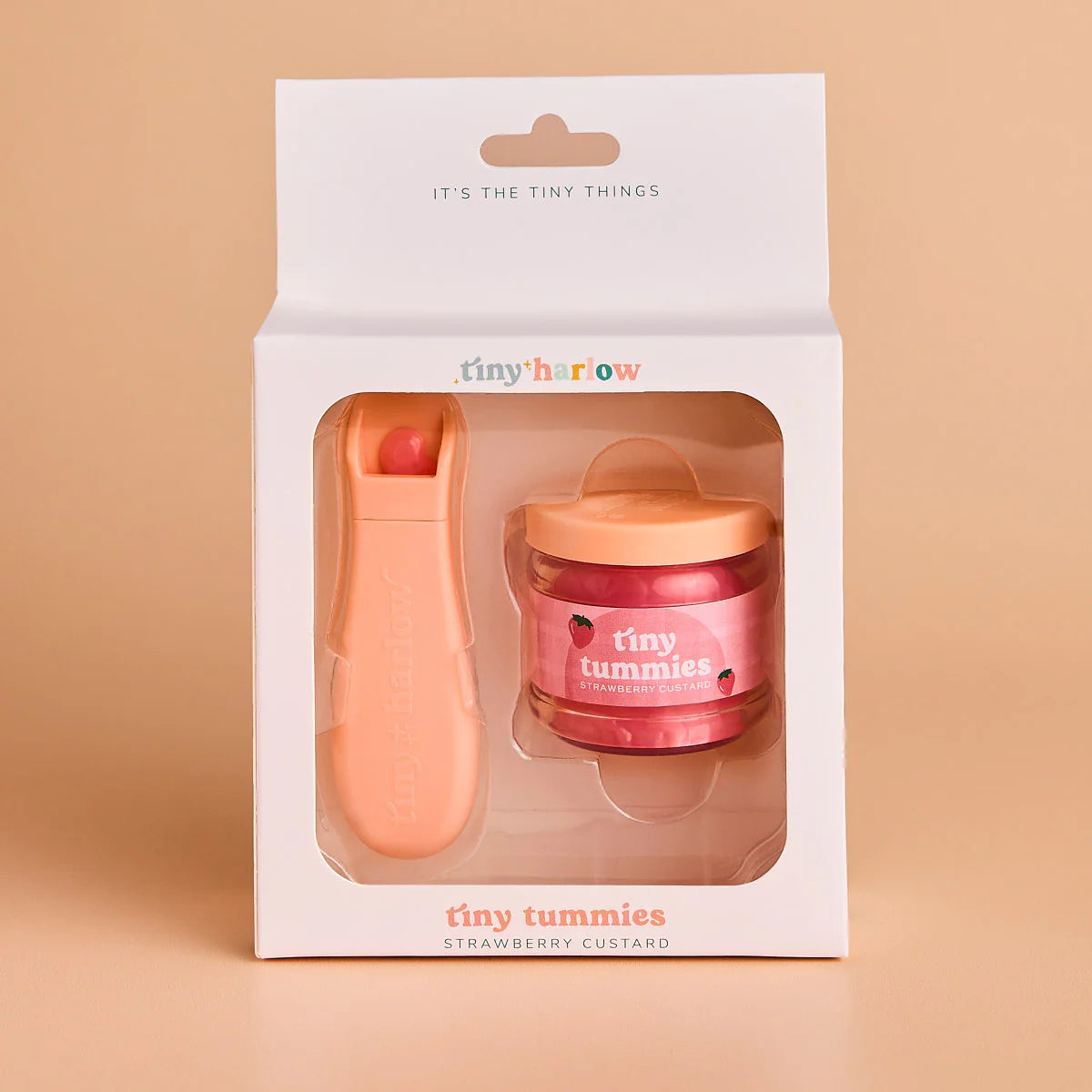 packaging of jar of tiny tummies pretend baby dolls food which is magic and disappearing, perfect gifting brand is tiny harlow and flavour is strawberry custard
