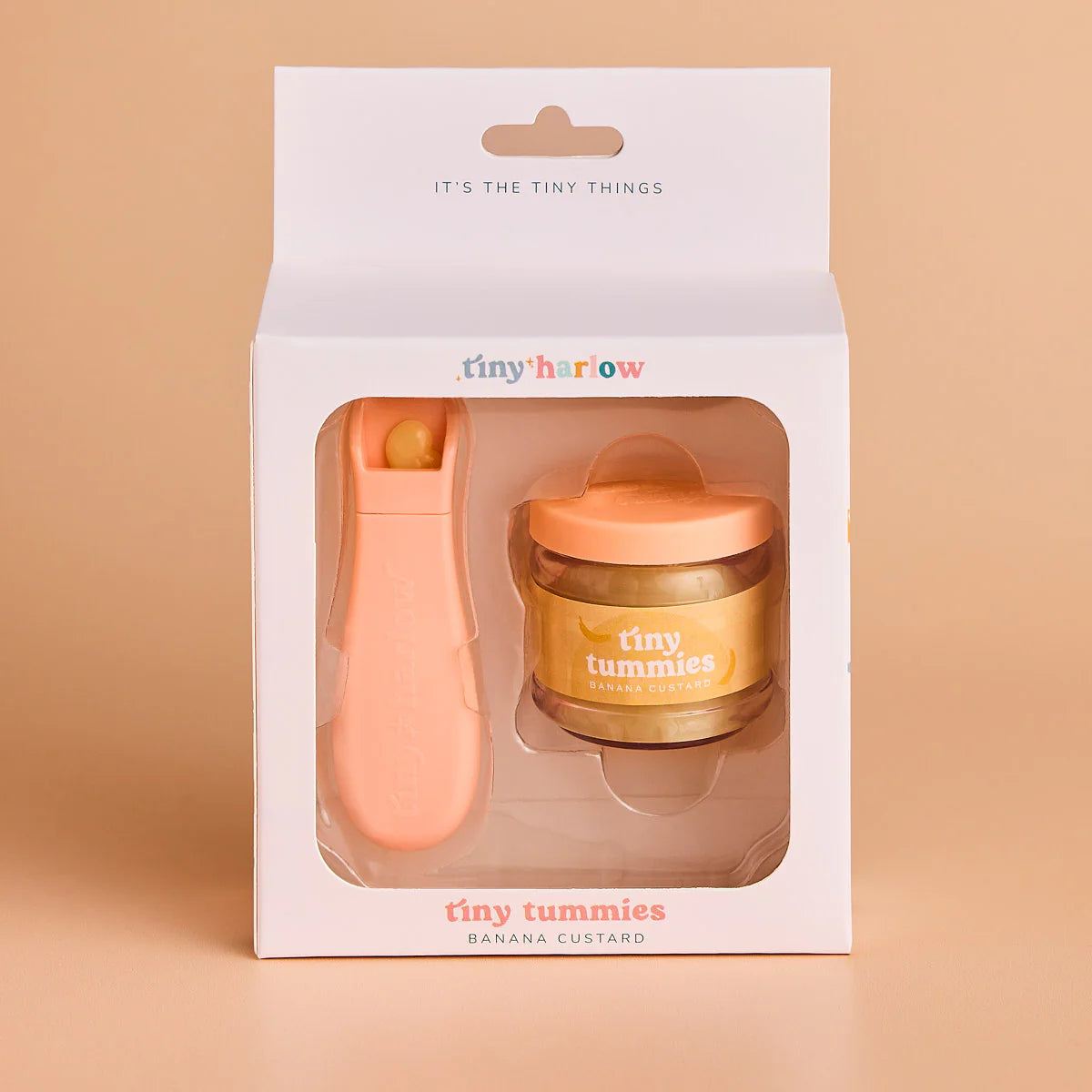 packaging of jar of tiny tummies pretend baby dolls food which is magic and disappearing, perfect gifting brand is tiny harlow and flavour is banana custard