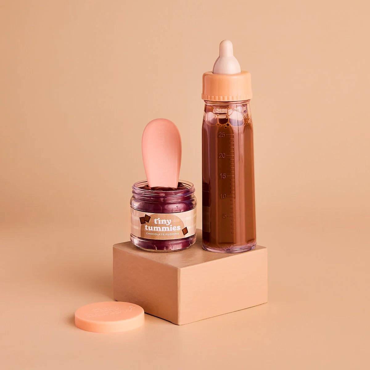 showcasing the tiny chocolate box gift set outside the box, for pretend play with baby dolls. great for gifting and this pack includes chocolate milk, chocolate pudding and the magic spoon