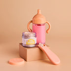 showcasing the my tiny birthday set gift pack which includes a sippy cup of strawberry milk, magic doll food jar and spoon in the flavour birthday cake. made by tiny harlow