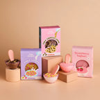 the tiny tummies cereal boxes and yoghurt box showcased. brand is tiny harlow and flavours are tiny loops cereal, tiny chocco loops cereal and strawberry yoghurt bowl