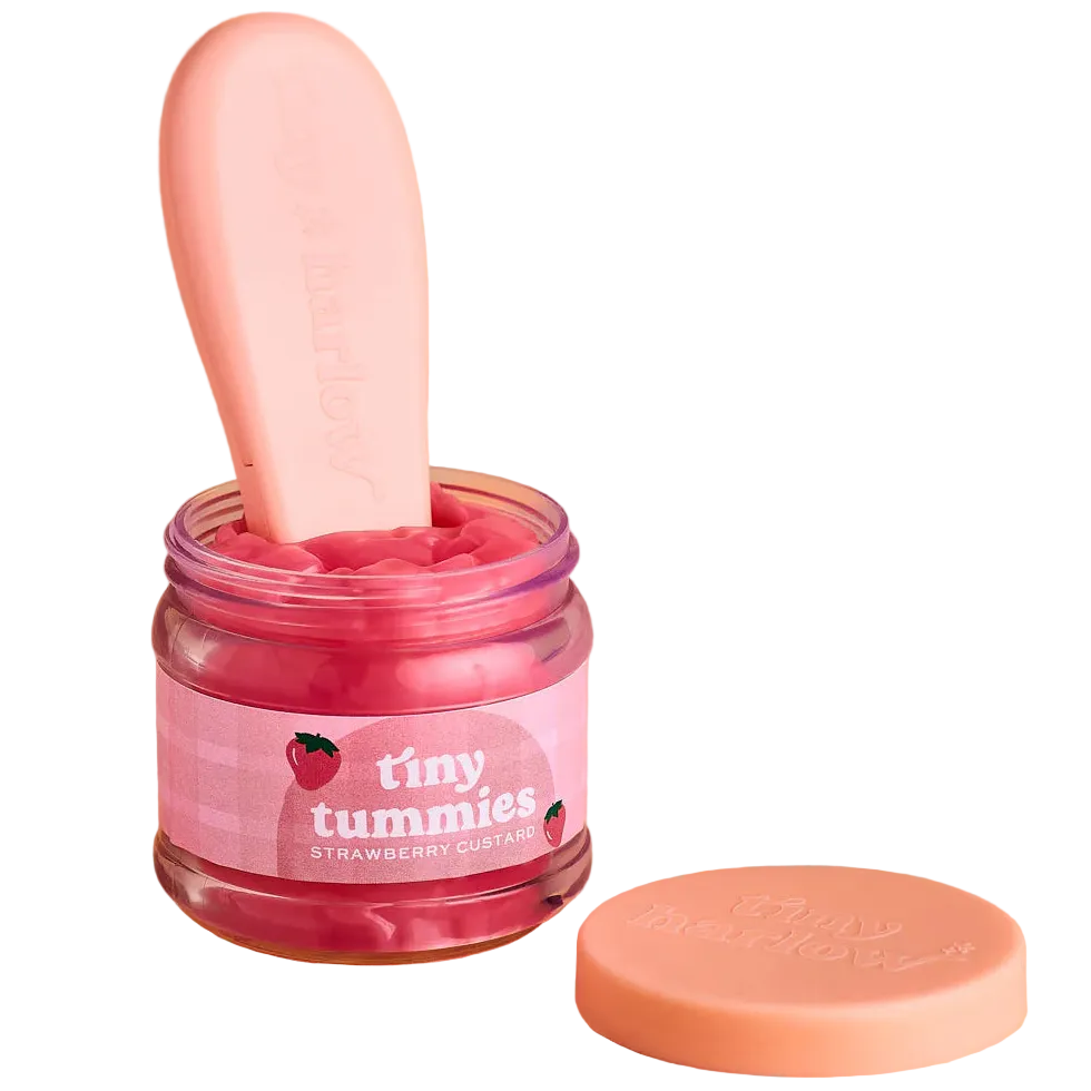 jar of tiny tummies pretend baby dolls food which is magic and disappearing, brand is tiny harlow and flavour is strawberry custard