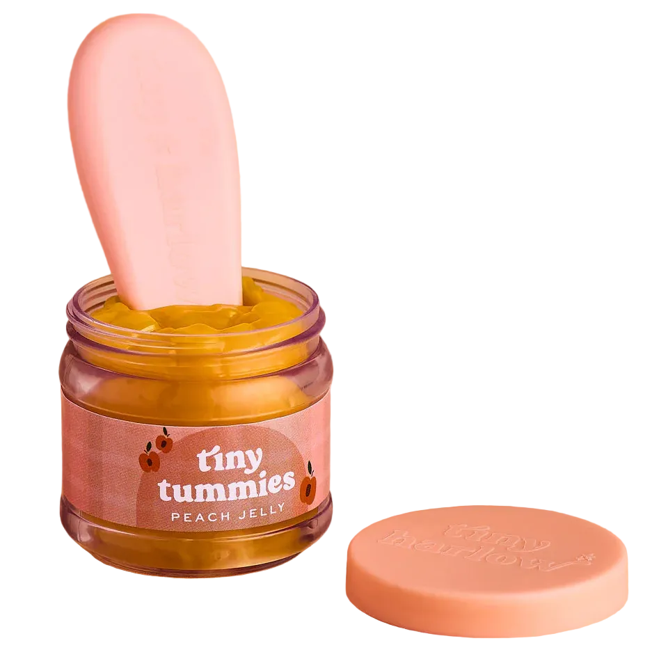 jar of tiny tummies pretend baby dolls food which is magic and disappearing, brand is tiny harlow and flavour is peach custard