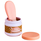 Jar of 'tiny tummies' ice cream with a pink spoon on a beige background