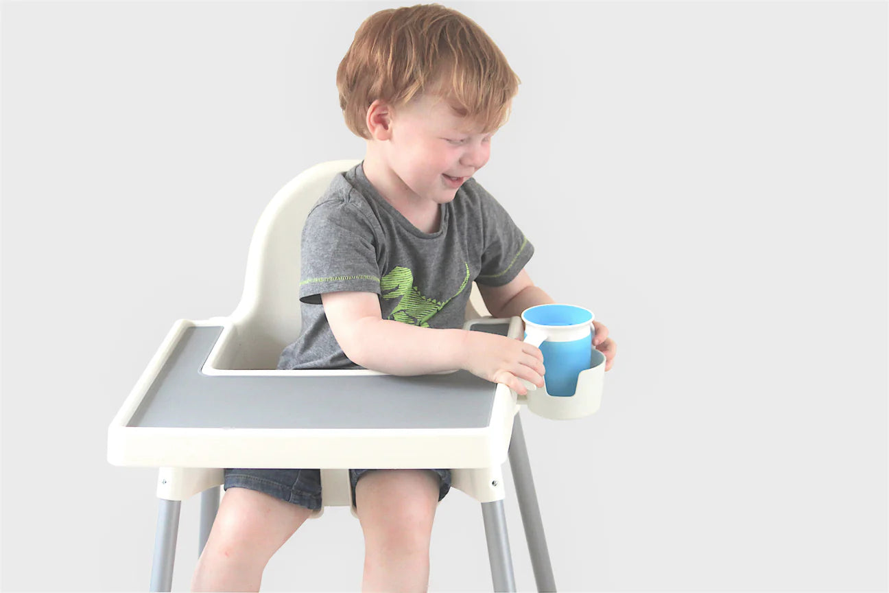kid accessing their toddle way highchair cup holder accessory fitted to kmart highchair