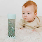 Soft mint baby calm down sensory bottle with stars and shimmering glitter by Jellystone Designs