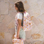 side view of girl wearing Fox & Fallow backpack for kids, perfect for school, daycare and everyday use. Spacious, practical and designed for little adventures. Personalisation of embroidery with name also available on bags in 2 placements. This print is daisy chain