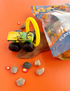 Resealable KidDough pouch with monster truck toys, road signs, rocks and sensory dough pieces designed for tactile fine motor and pretend vehicle play