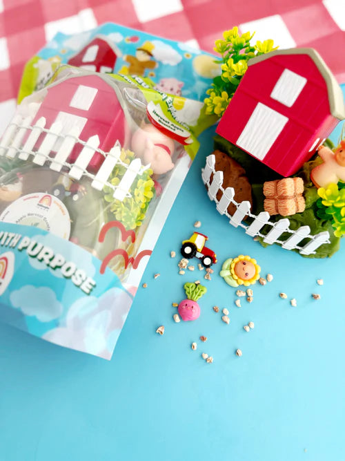 Resealable KidDough pouch with farm themed charms, barn and animal figurines spread out for hands-on sensory and small world play