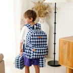 child wearing Fox & Fallow backpack for kids, perfect for school, daycare and everyday use. Spacious, practical and designed for little adventures. Personalisation of embroidery with name also available on bags in 2 placements. This print is blue diamonds