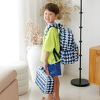 child side view wearing Fox & Fallow backpack for kids, perfect for school, daycare and everyday use. Spacious, practical and designed for little adventures. Personalisation of embroidery with name also available on bags in 2 placements. This print is blue diamonds with matching lunch bag